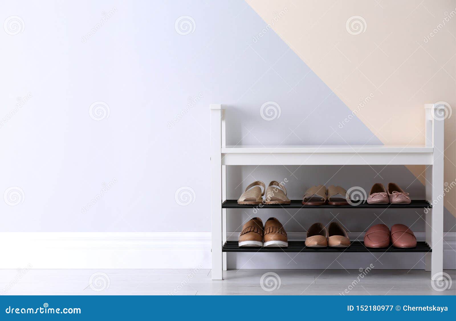 Shoe Rack With Different Footwear Near Color Wall Stylish