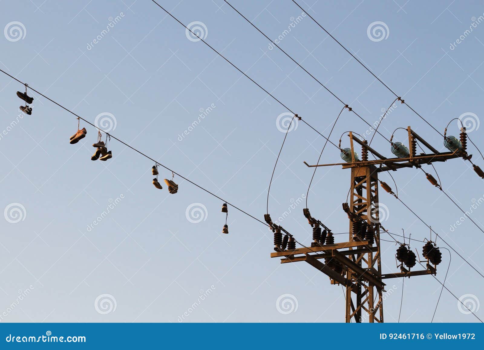Shoes Dangling on a Electric Cable Over the Street Stock Photo Image