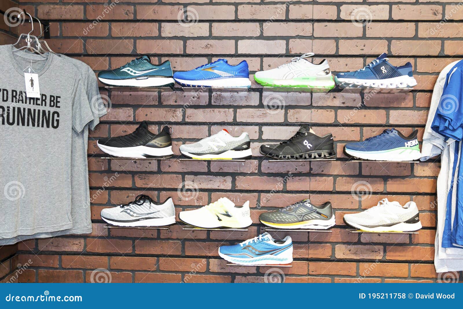 Shoes and Shirts Hanging on the Wall of a Running Shoe Store Editorial  Stock Photo - Image of august, interior: 195211758