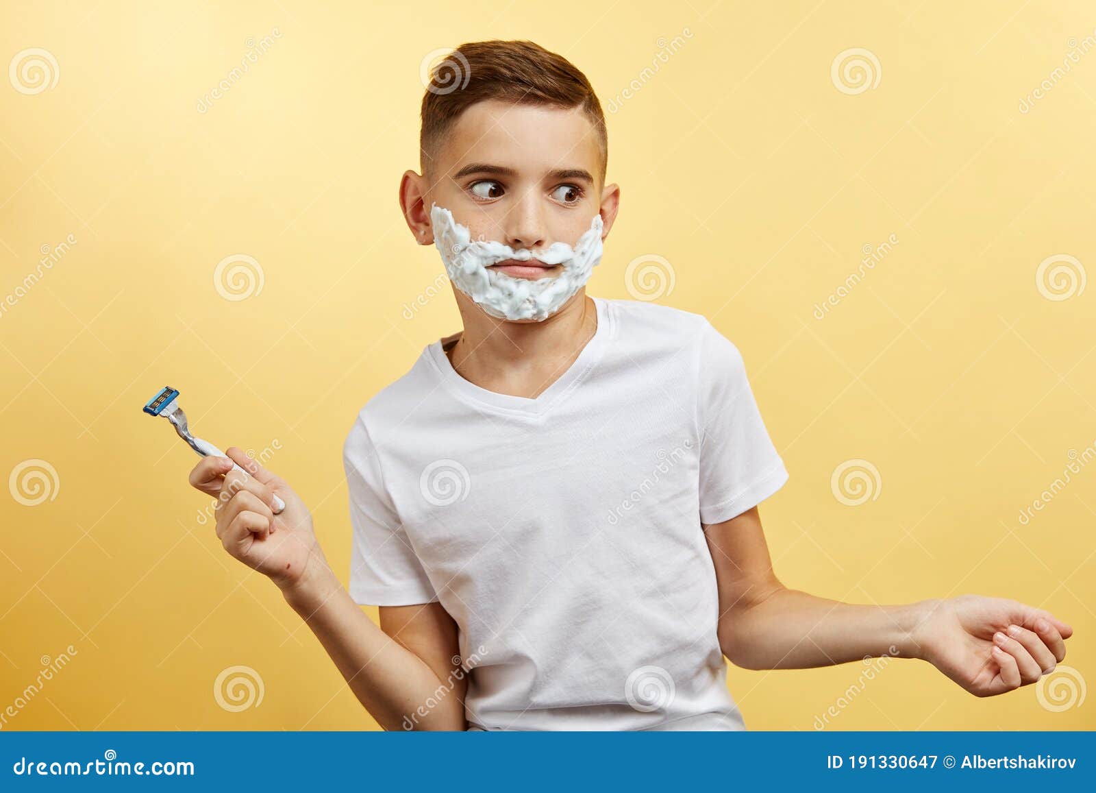 Shoking Boy Preparing for Shaving Face Over Yellow Background Stock