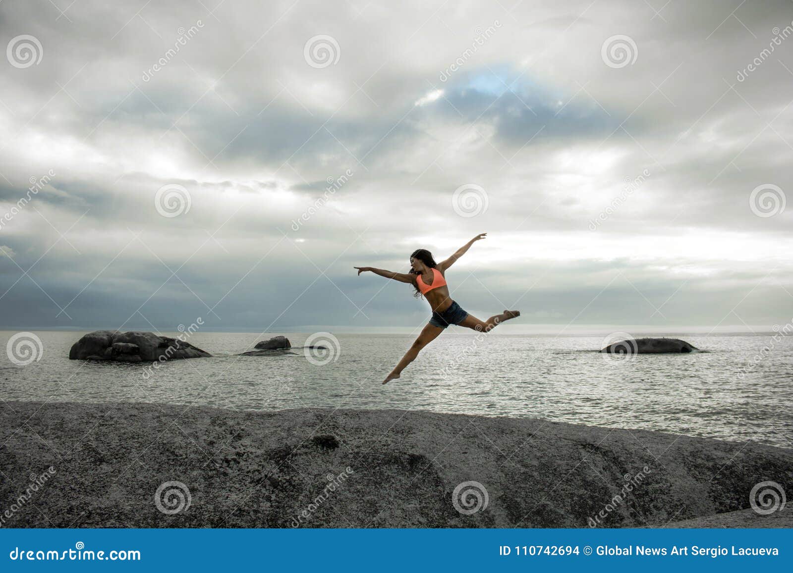 Woman Jumping On A Rock At Sunset On Bakovern Beach Cape Town Stock Photo Image Of Bakoven