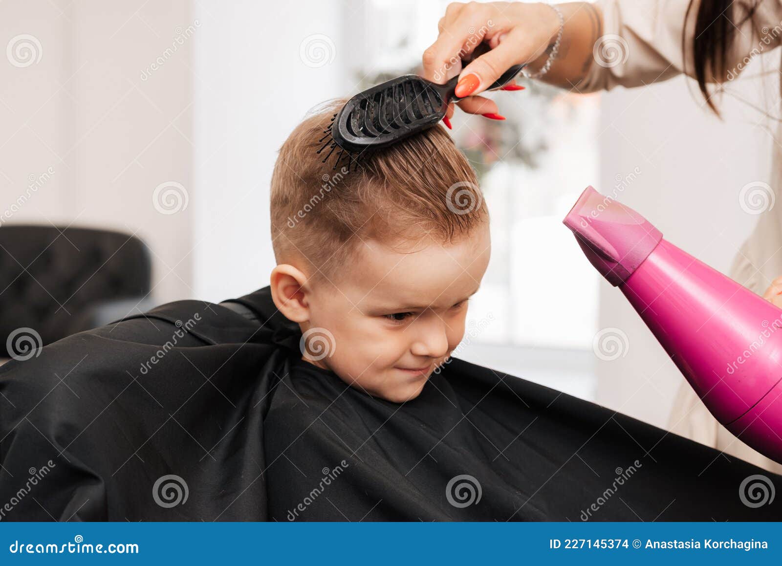 Shooting in a Beauty Salon. the Hairdresser Does the Styling of the Little  Boy with a Hair Dryer and a Comb. Stock Photo - Image of head, salon:  227145374
