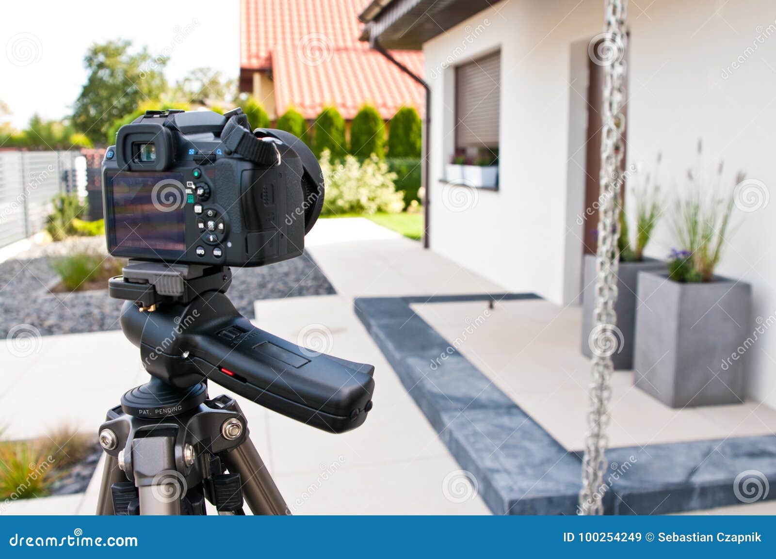 shooting house exterior, photographer camera, tripod and ballhead