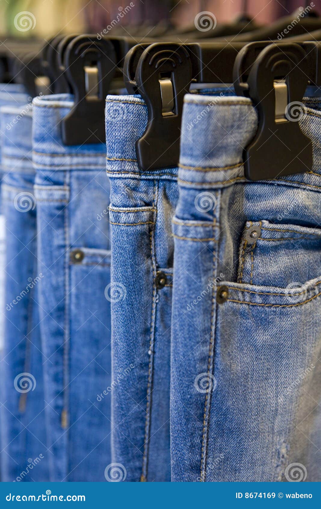 Male hand customer choosing black men jeans or denim pants