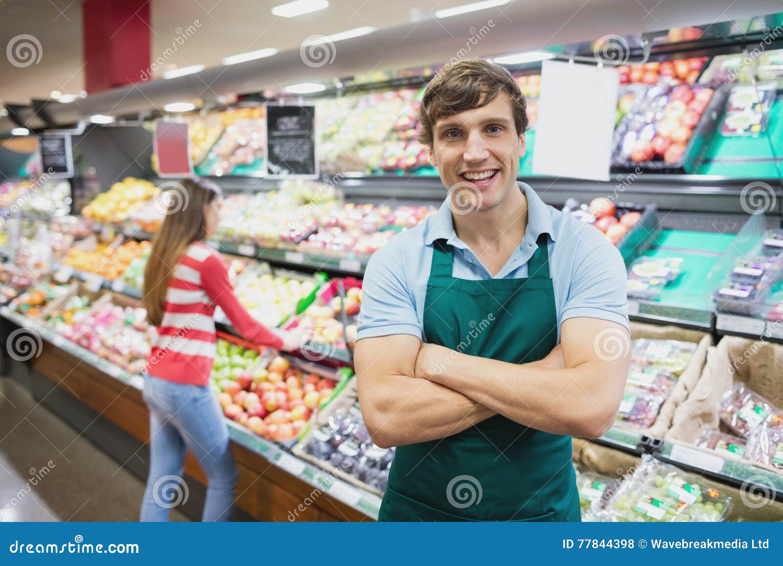 shop assistant posing with arms crossed