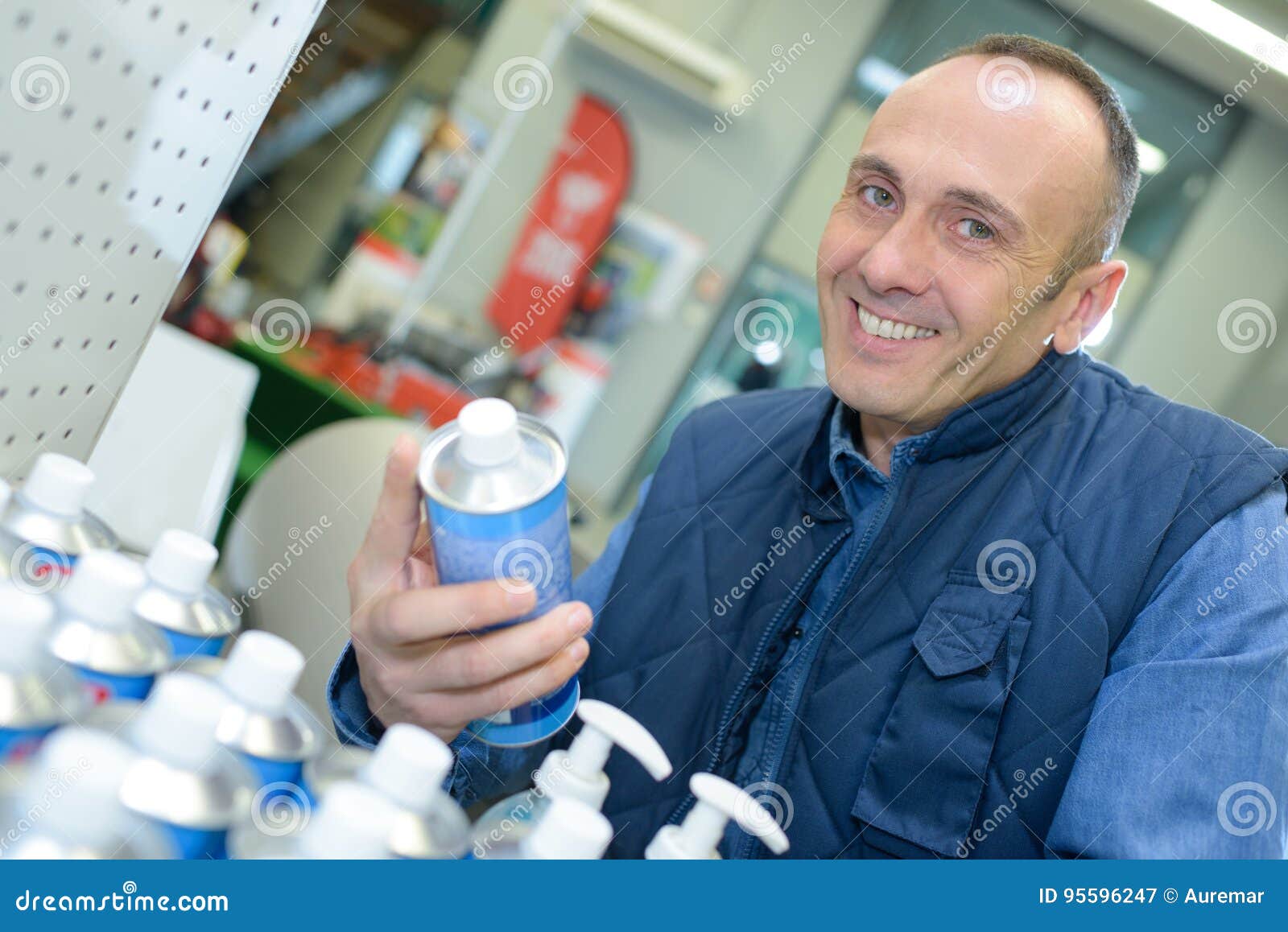 shop assistant tidying up productos on shelf