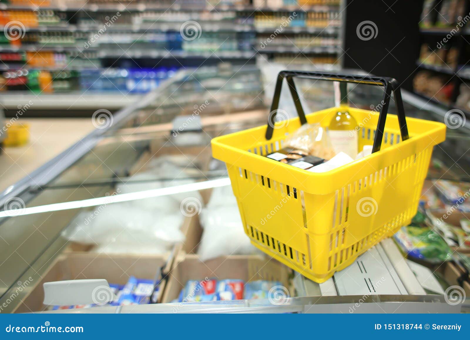 Shopping Basket on Refrigerator of Modern Grocery Store Stock Photo