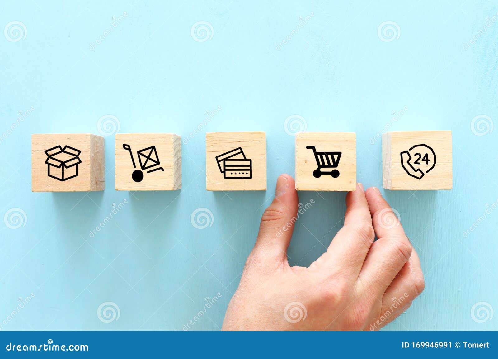 shopping and bussines concept. hand picking wooden cube