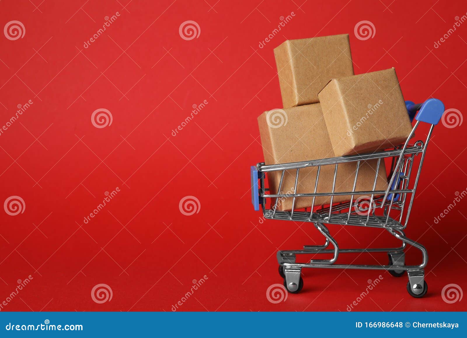 shopping cart with boxes on red background. logistics and wholesale concept