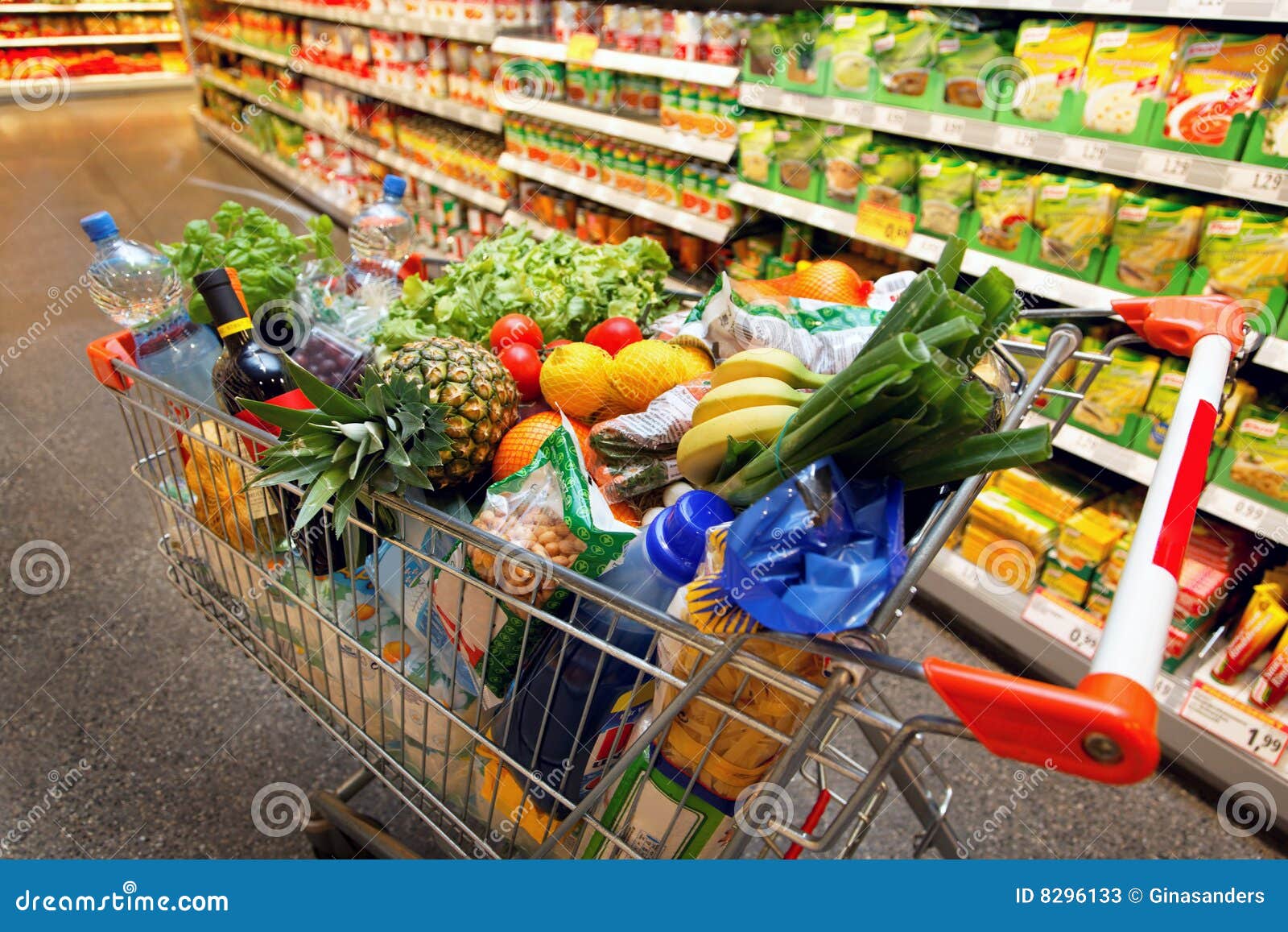 shopping cart with fruit in supermarket