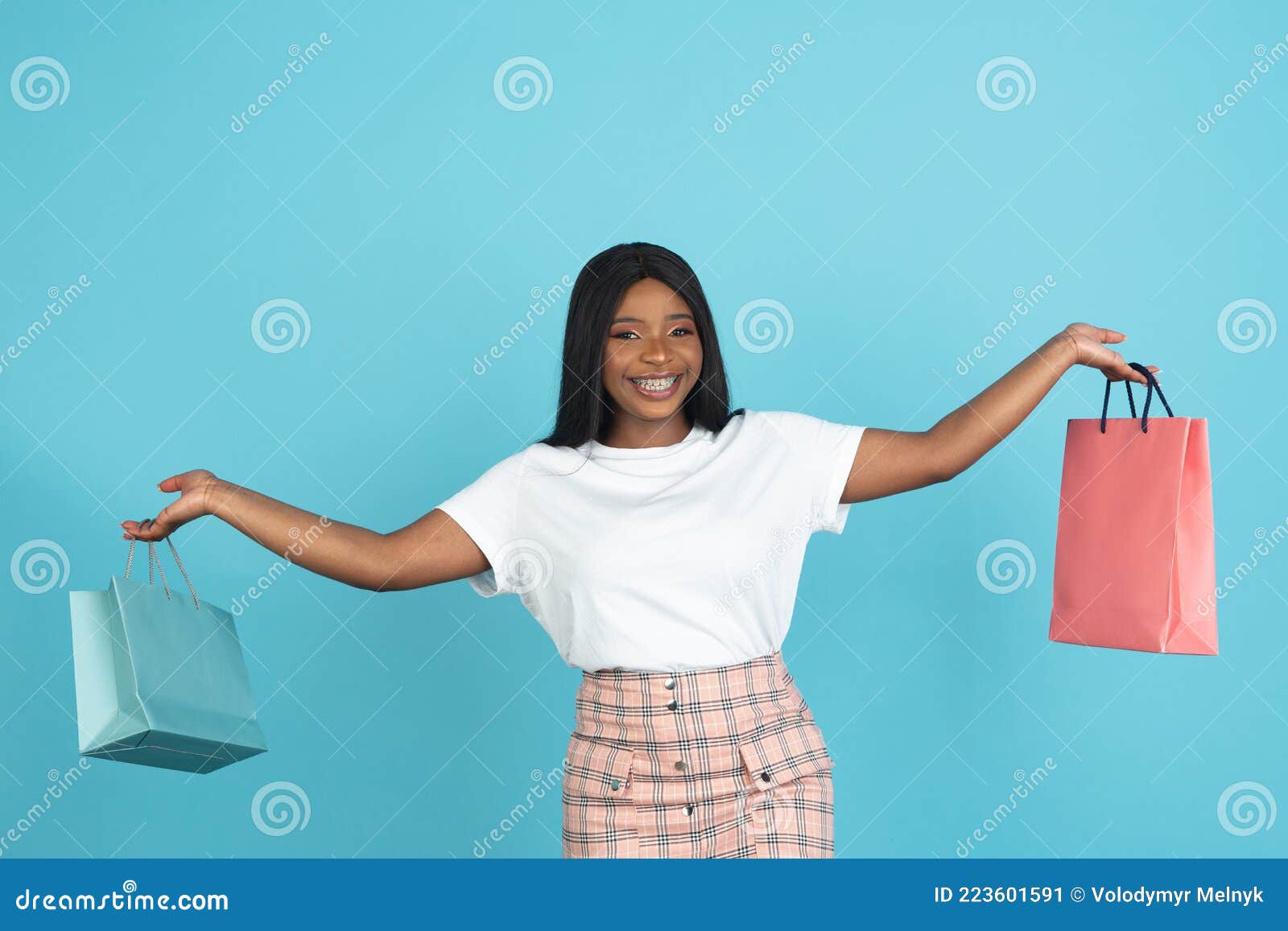 Portrait of Smiling African Young Woman with Paper Bags Isolated on ...