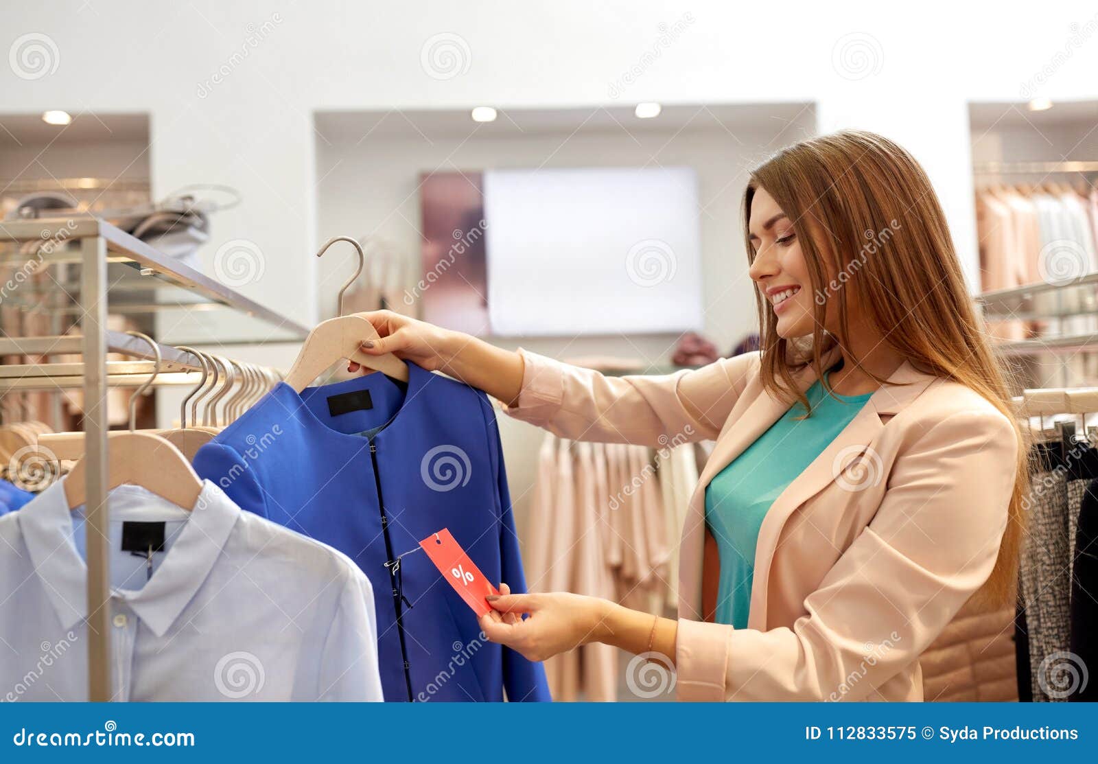 Happy Woman Choosing Clothes at Clothing Store Stock Image - Image of ...