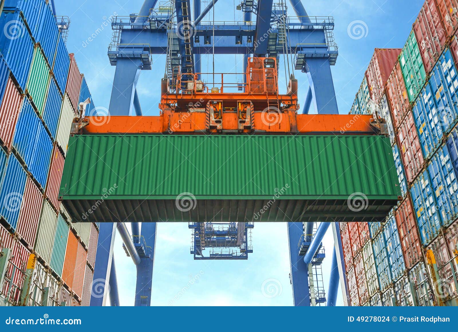 shore crane loading containers in freight ship