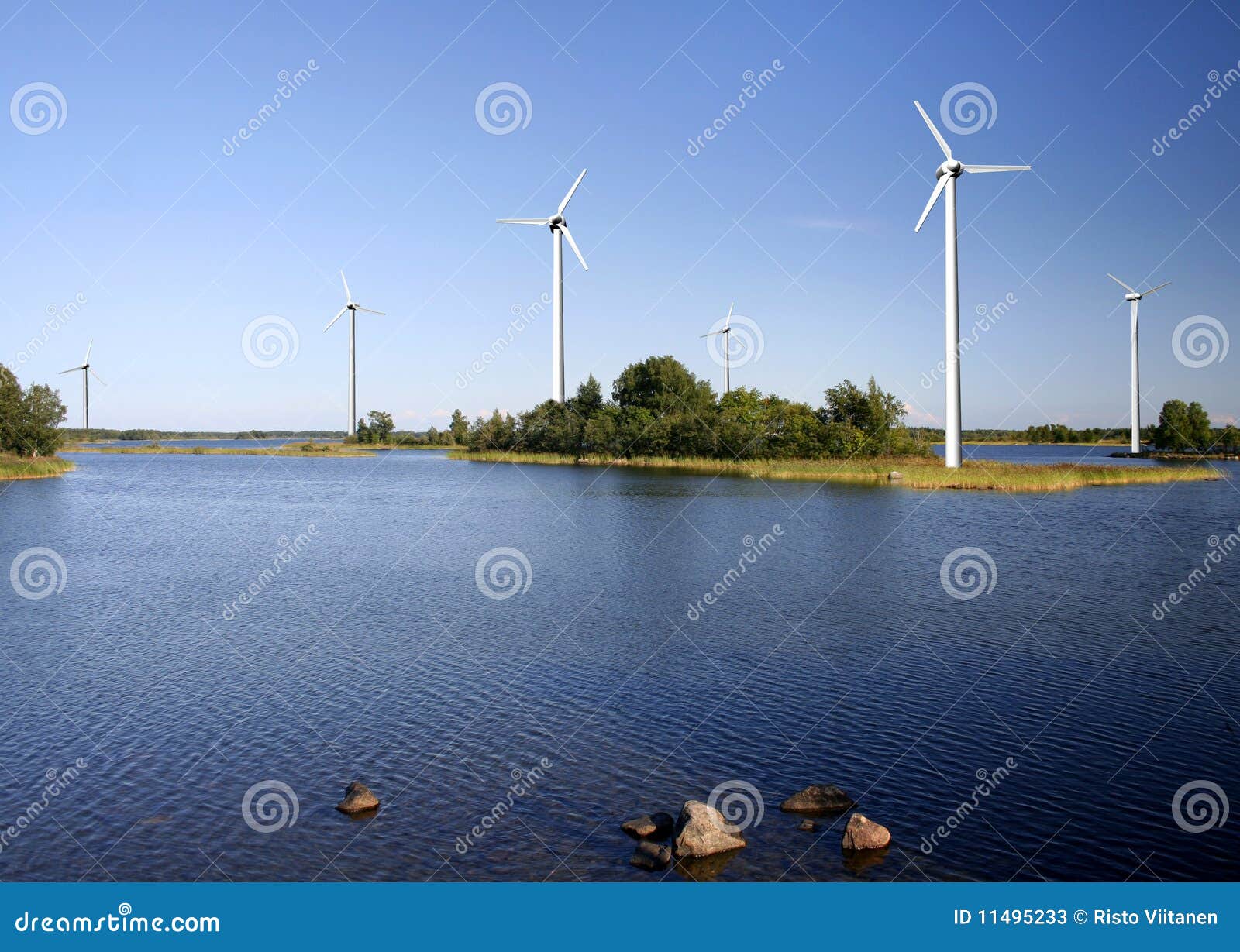 Wind power farm producing renewable electricity at seashore.