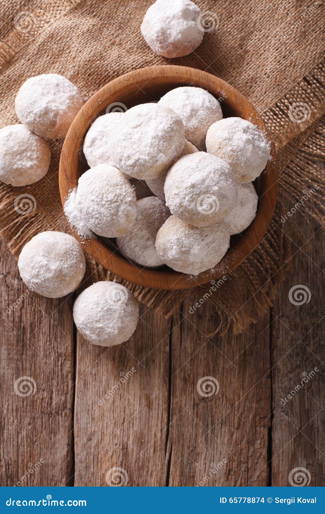 shortbread polvoron in a wooden bowl. vertical top view