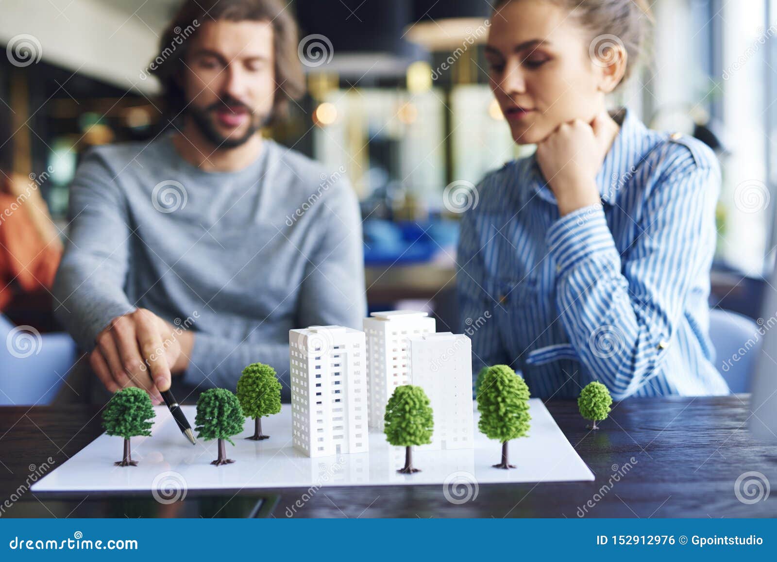 architectural model and young adults architects in the background