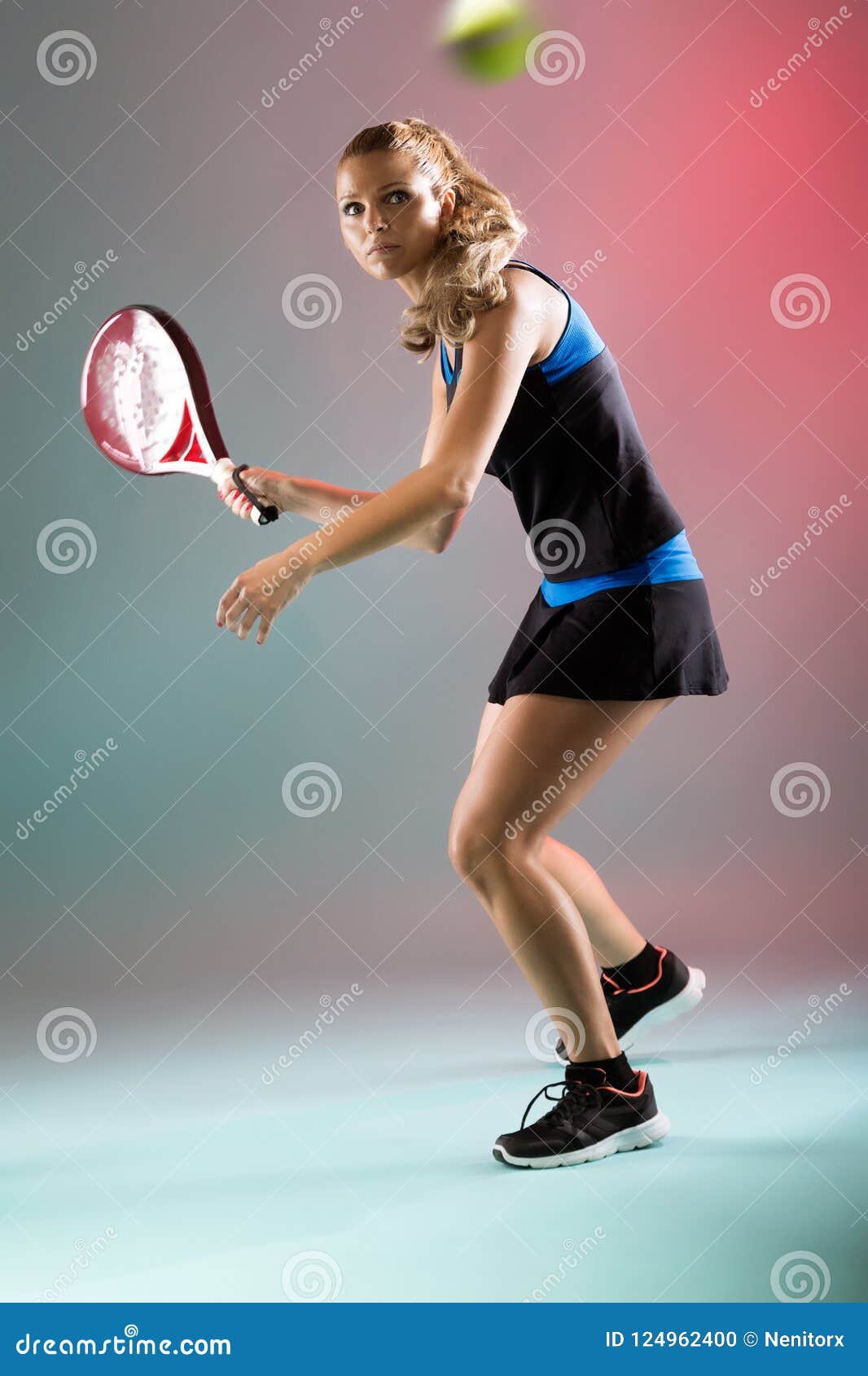 beautiful young woman playing padel indoor over multicolored background.