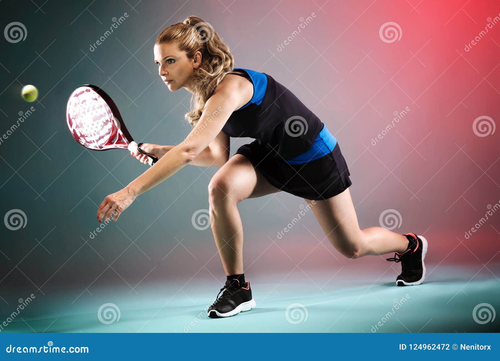 beautiful young woman playing padel indoor over multicolored background.