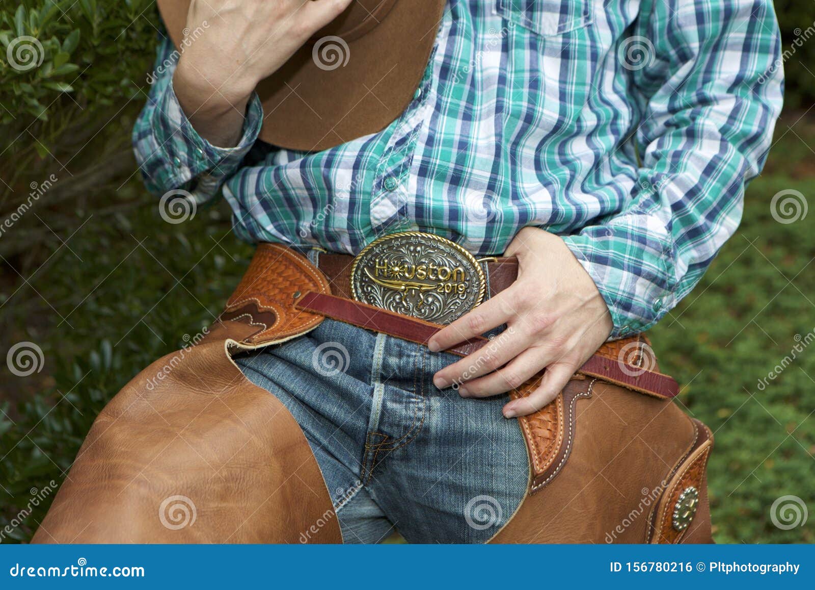 Roc, make sure you slow down in Casper Shot-cowboy-mid-section-green-white-blue-checkered-shirt-jeans-brown-hat-resting-chest-partially-shown-left-thumb-156780216