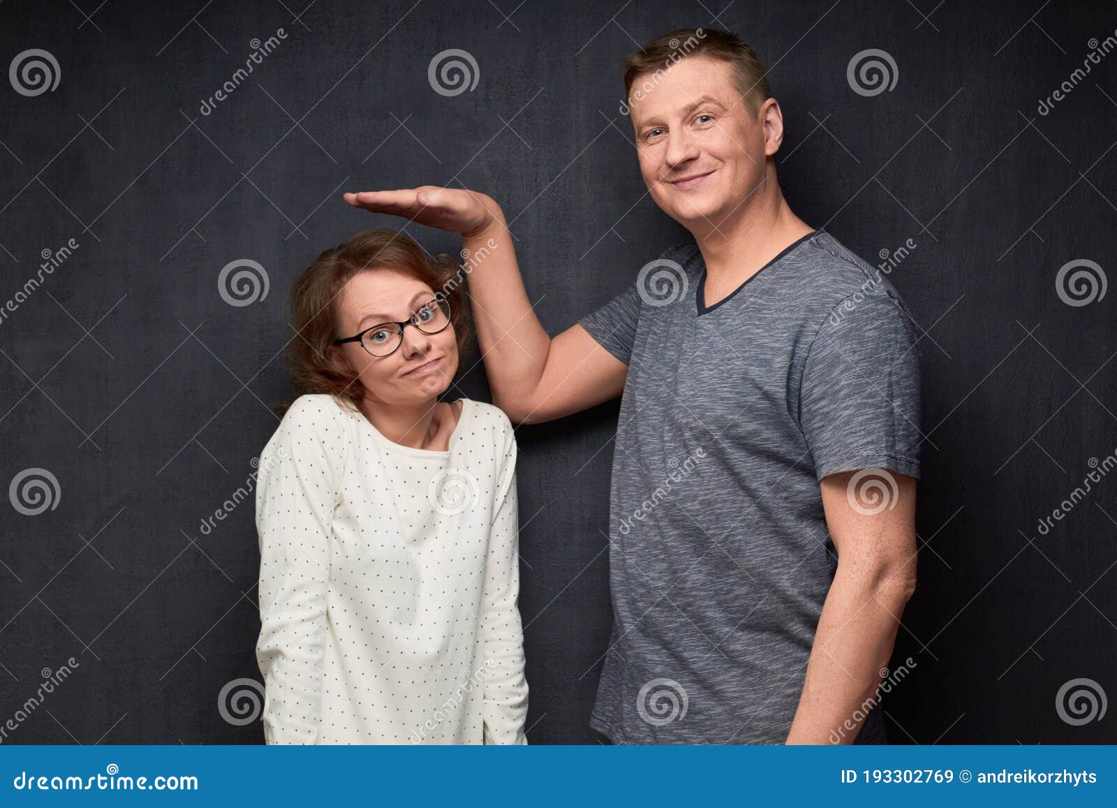 shot of funny tall man and short woman