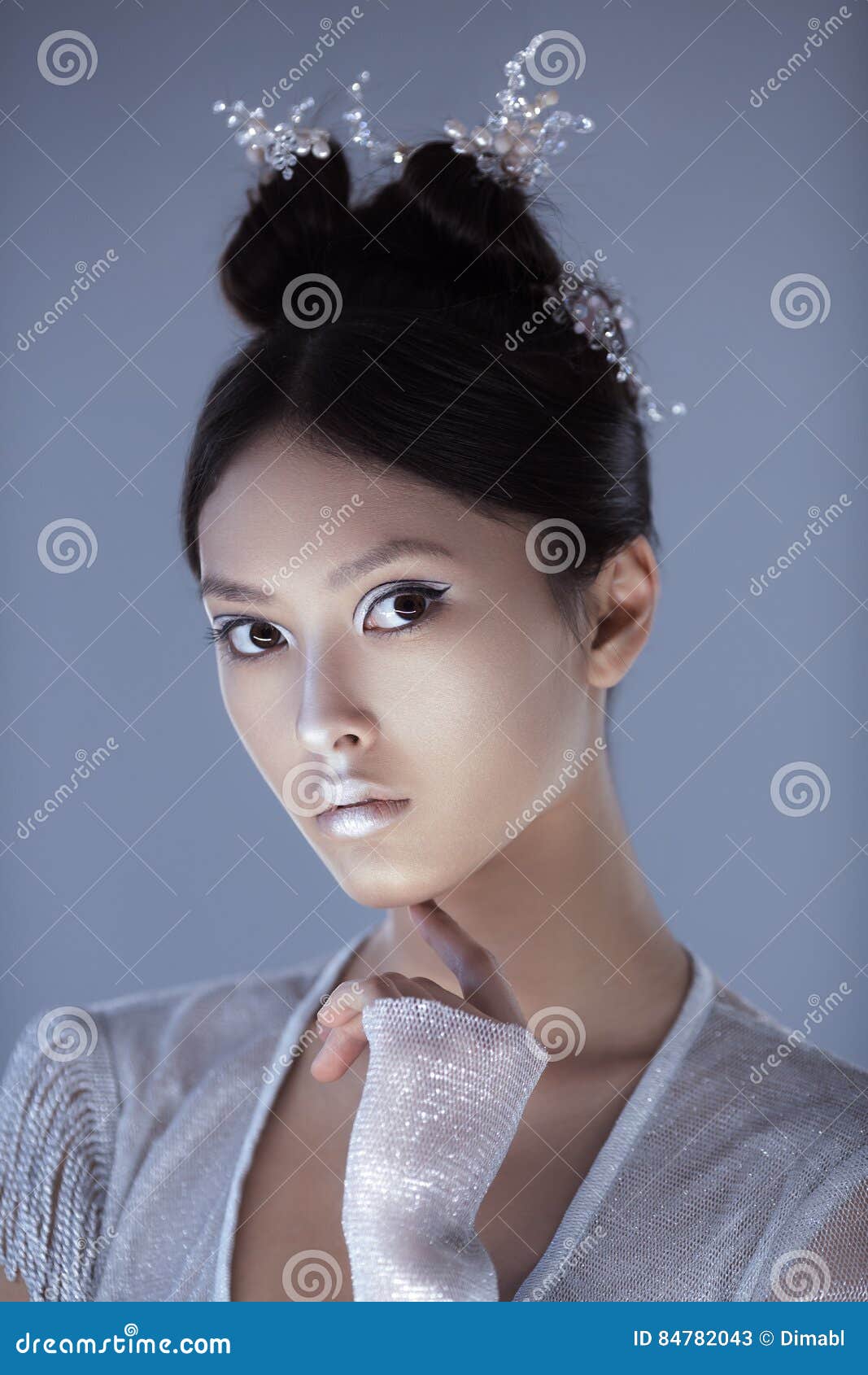 Futuristic Fashion Young Woman. Beautiful Young Multi-racial Asian  Caucasian Model Cyber Girl In Silver Urban Clothes With Conceptual  Hairstyle And Make-up Against White Background In Full Lenght. Sci-fi  Poster Style. Stock Photo