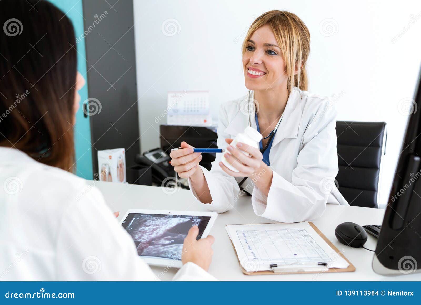 Pretty Young Woman Gynecologist Doctor Prescribing Medication For Pregnant In The Medical 
