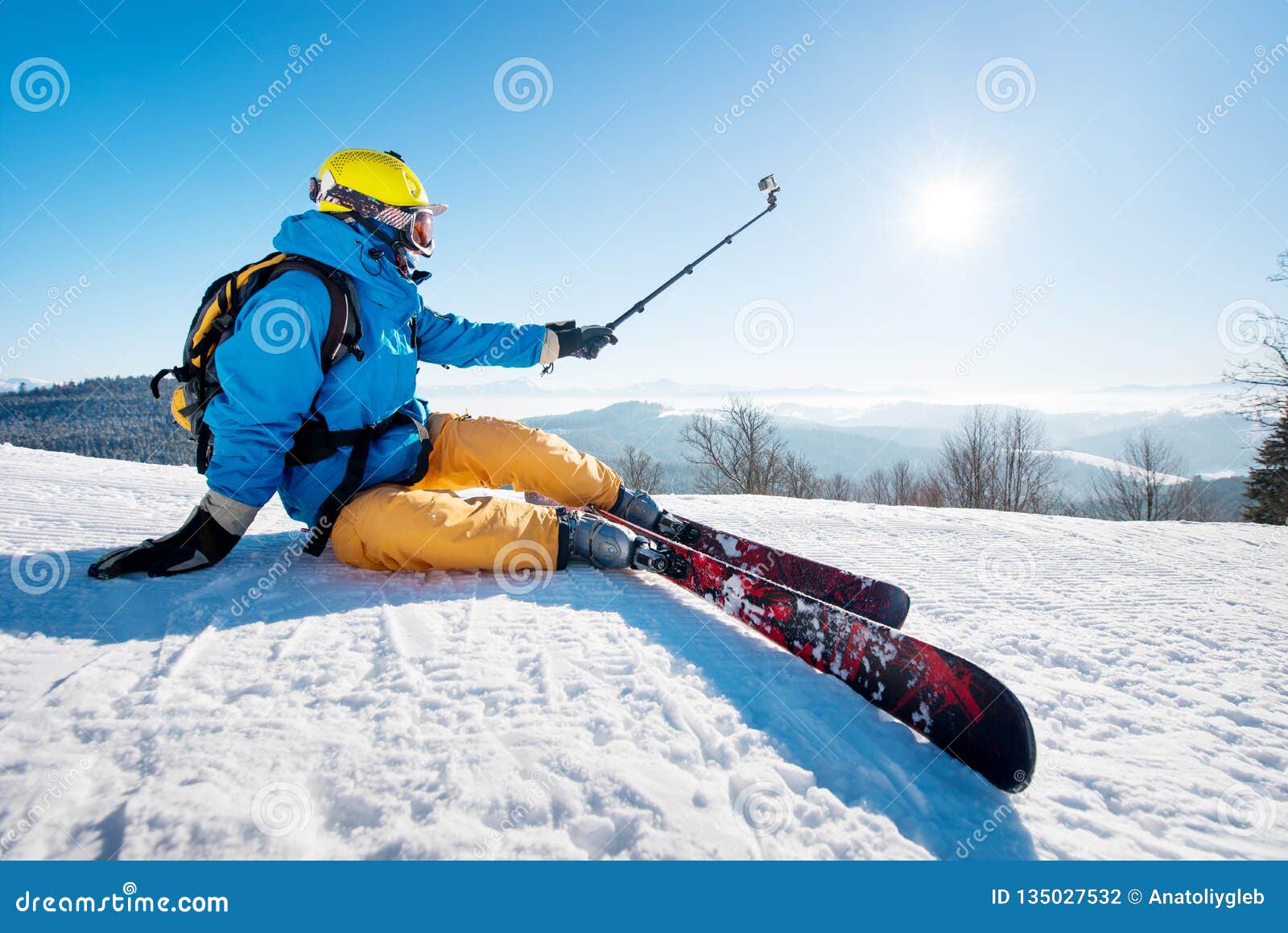 Shot of a Skier Sitting on the Ski Slope Taking a Selfie Using Selfie ...