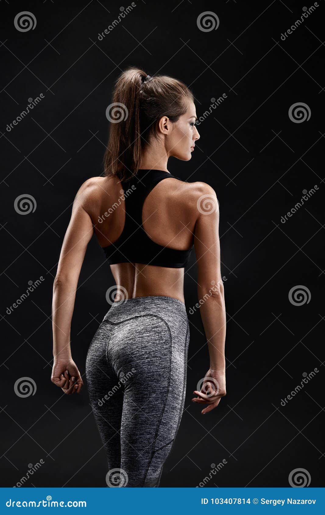 Shot of a strong woman with muscular abdomen in sportswear