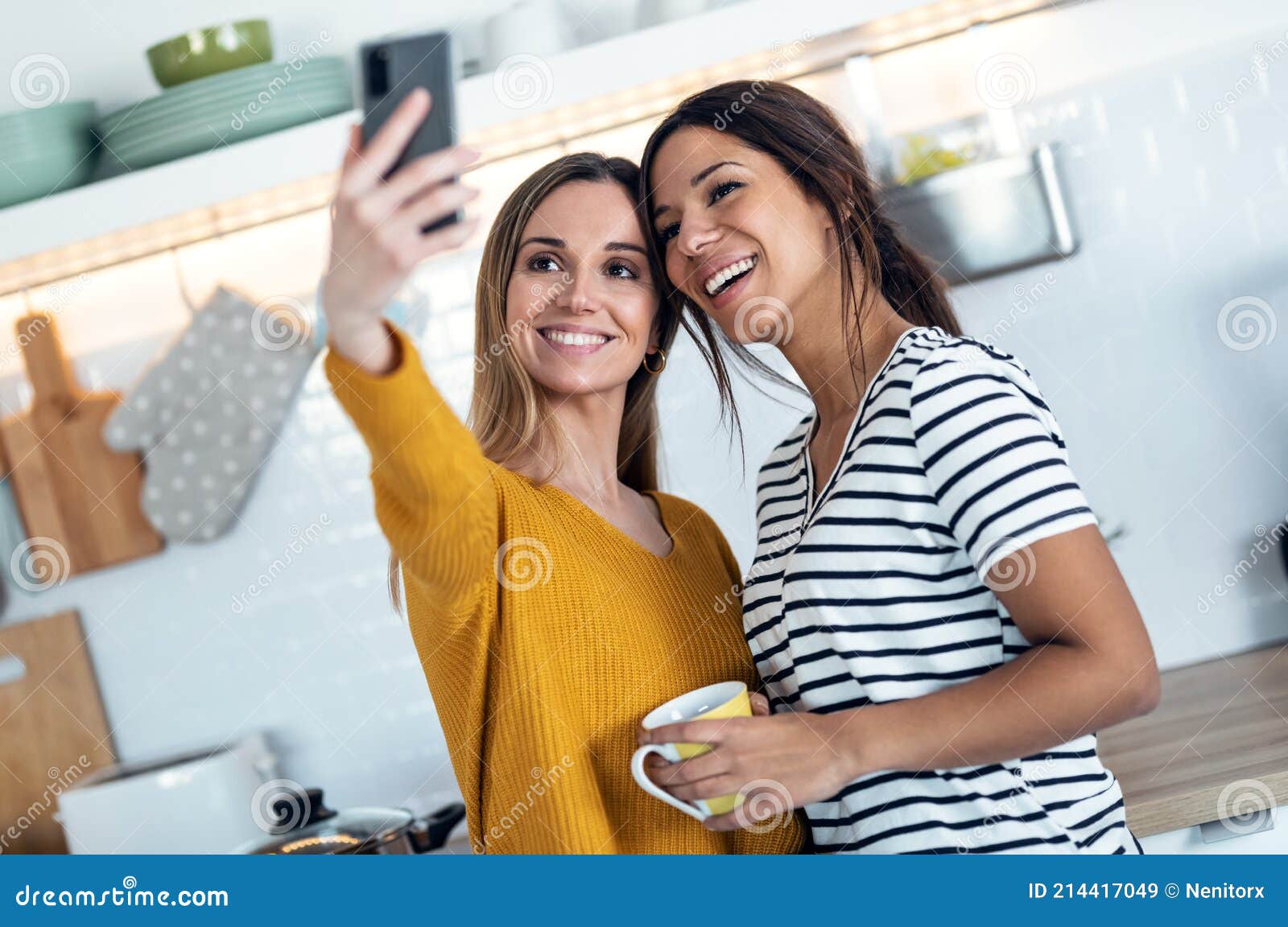 Two Beautiful Woman Friends Having Breakfast and Drinking Coffee while ...