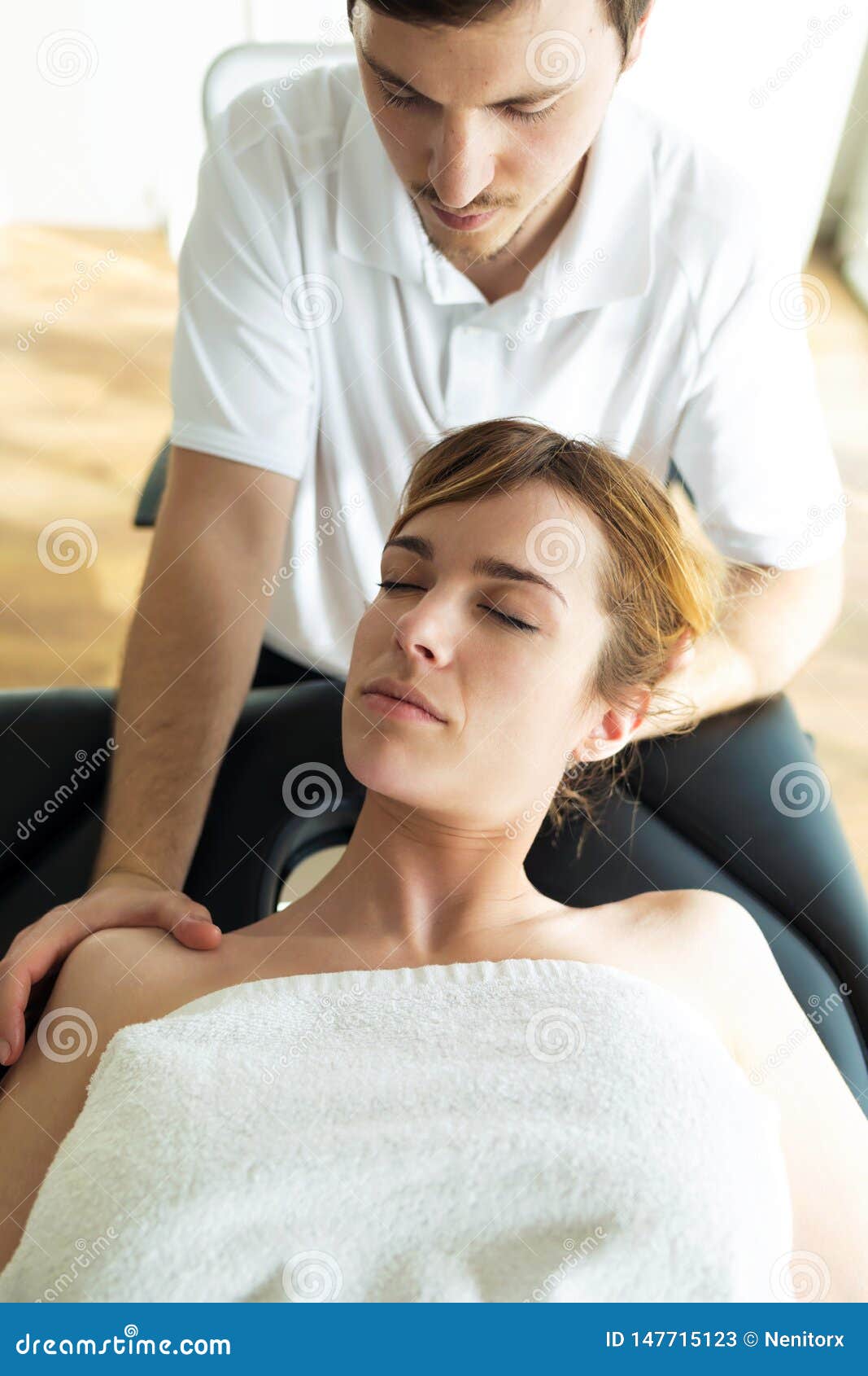 Young Physiotherapist Doing A Neck Treatment To The Patient In A Physiotherapy Room Stock Image