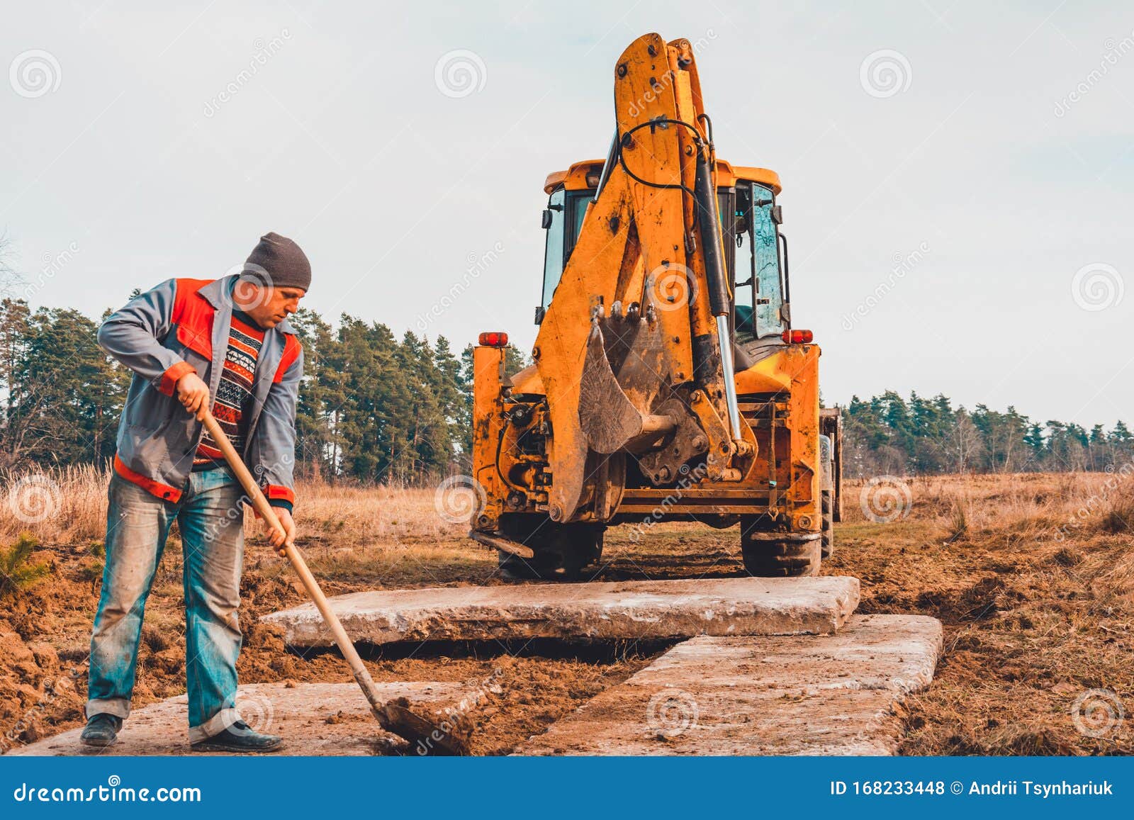 The Shovel Worker Cleans the Soil after Digging the Excavator, Laying