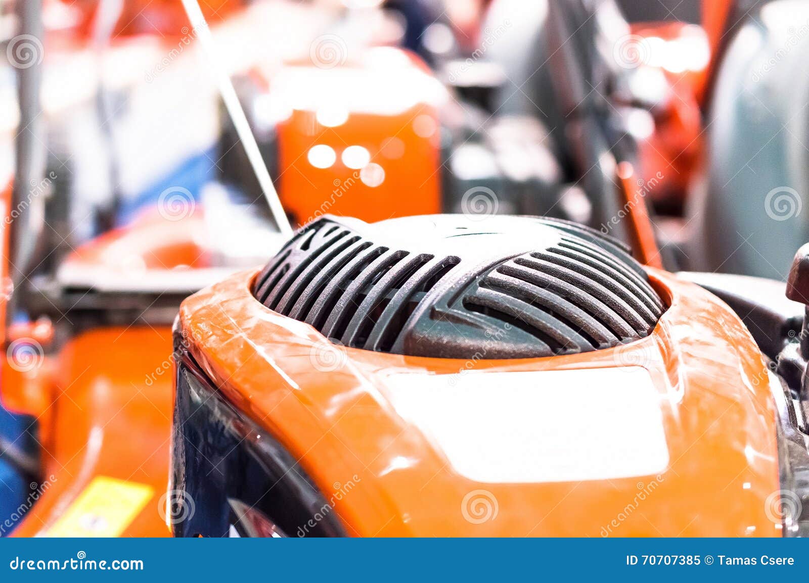 Showcase of the New Powerful Orange Lawn Mower in Store Stock Image