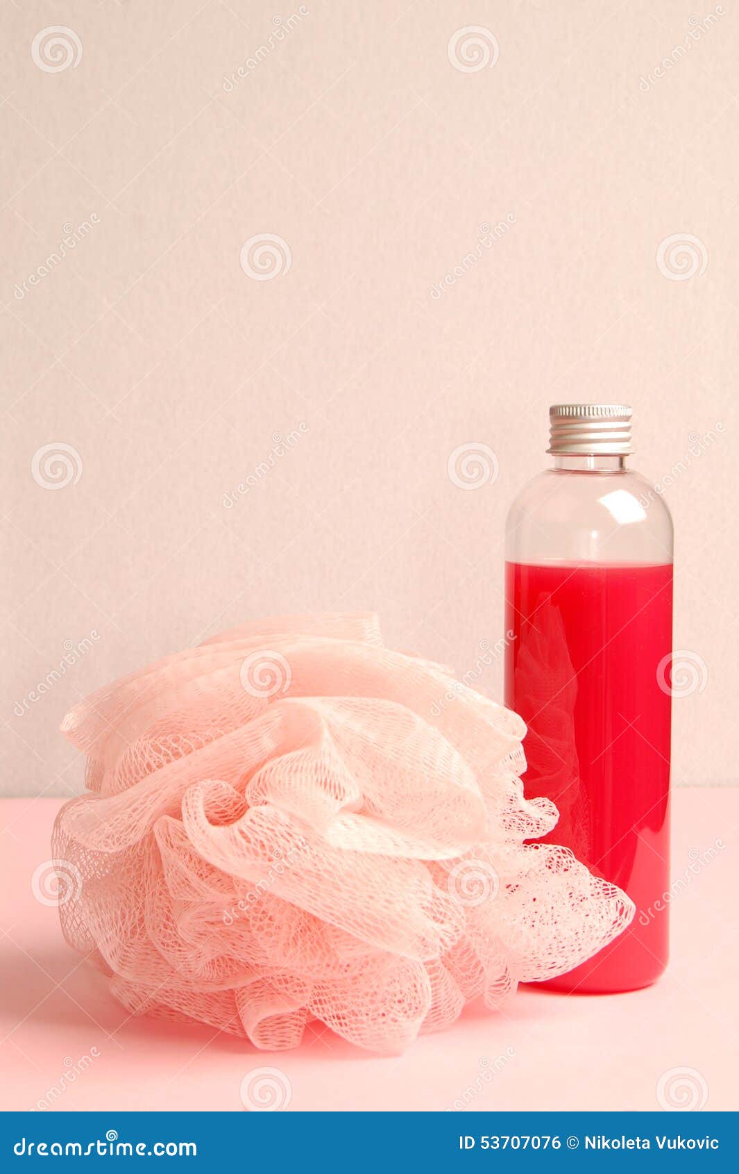 Still life from red shower gel and bath sponge.