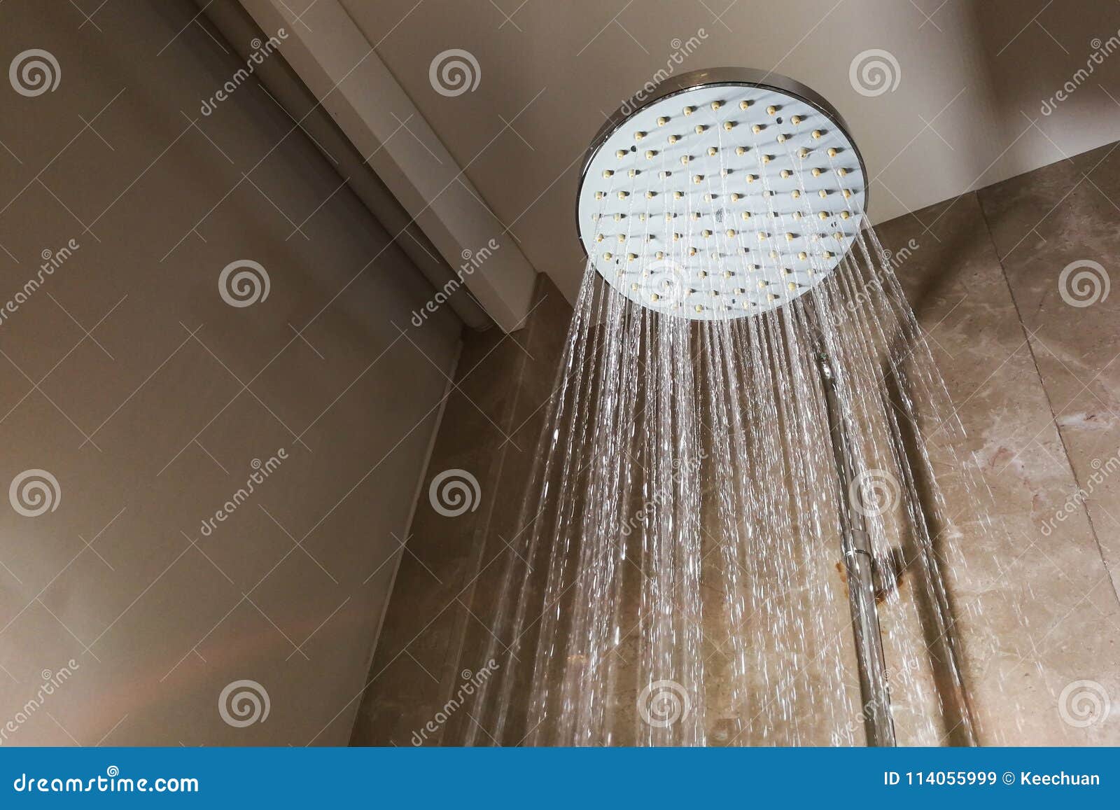 Shower Head with Refreshing Water Droplets Spraying Down in Bath Stock