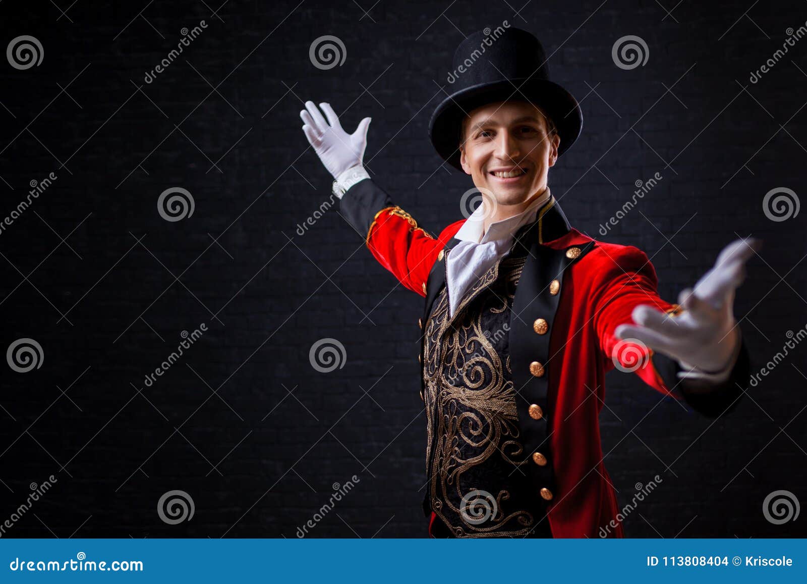 showman. young male entertainer, presenter or actor on stage. the guy in the red camisole and the cylinder.