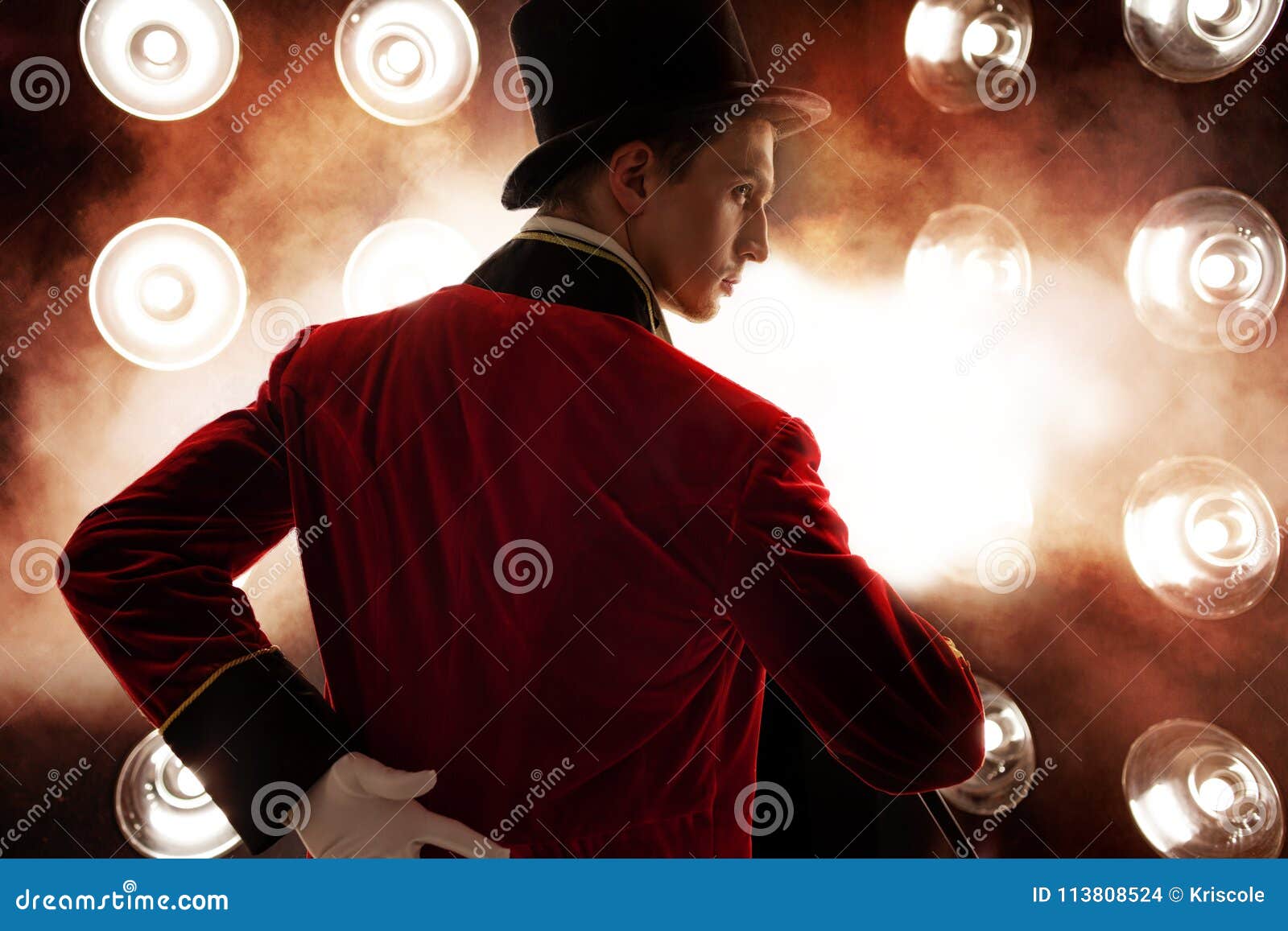 showman. young male entertainer, presenter or actor on stage. the guy in the red camisole and the cylinder.