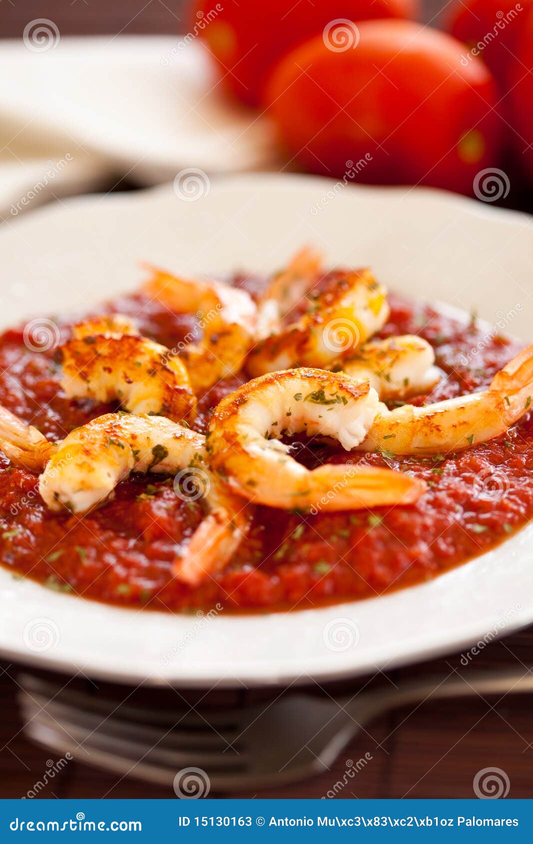 Plate of shrimp roasted with fried tomato