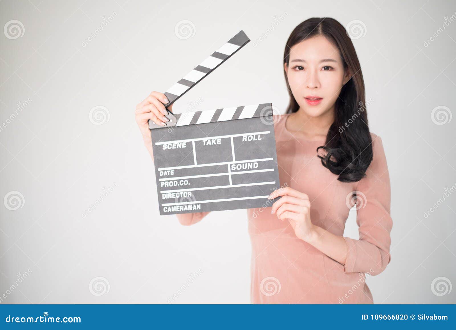 sian woman holding movie clapper board  on white background. cinematography, communication arts, casting, audition, movie