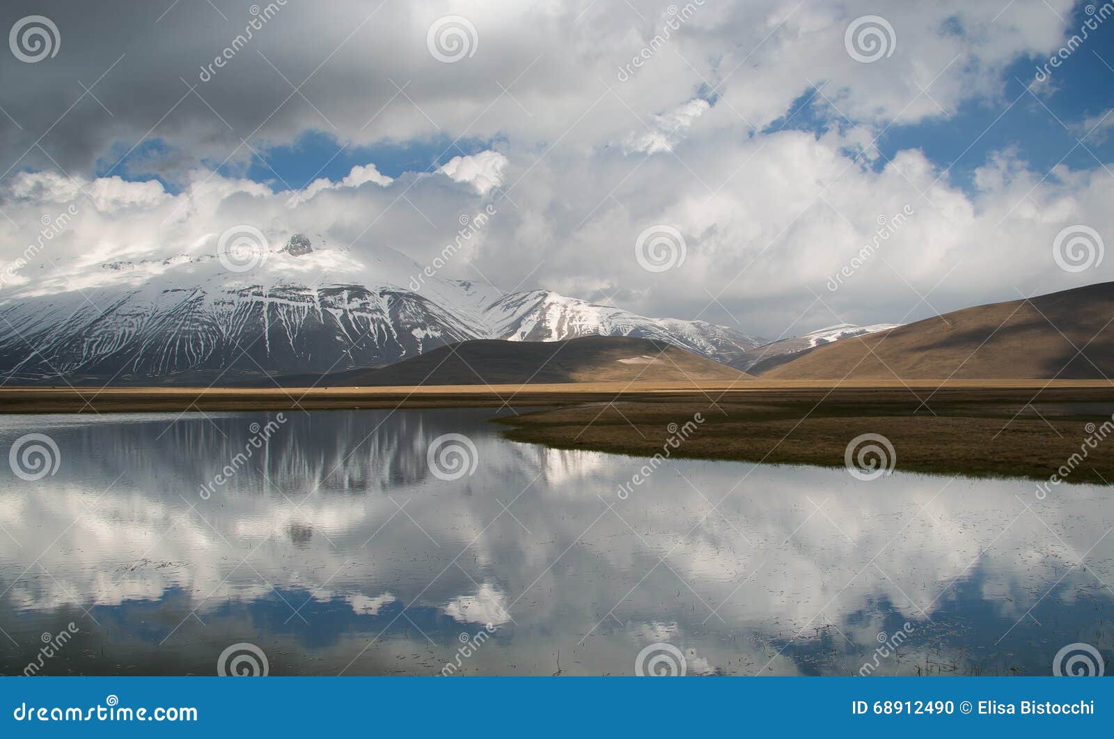 sibillini mountains reflected in the water in umbria