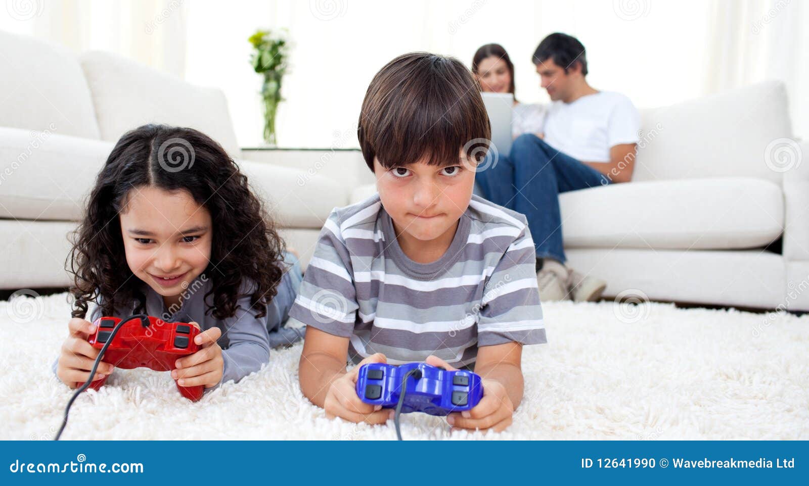 Siblings Playing Video Games Lying on the Floor Stock Photo Image of