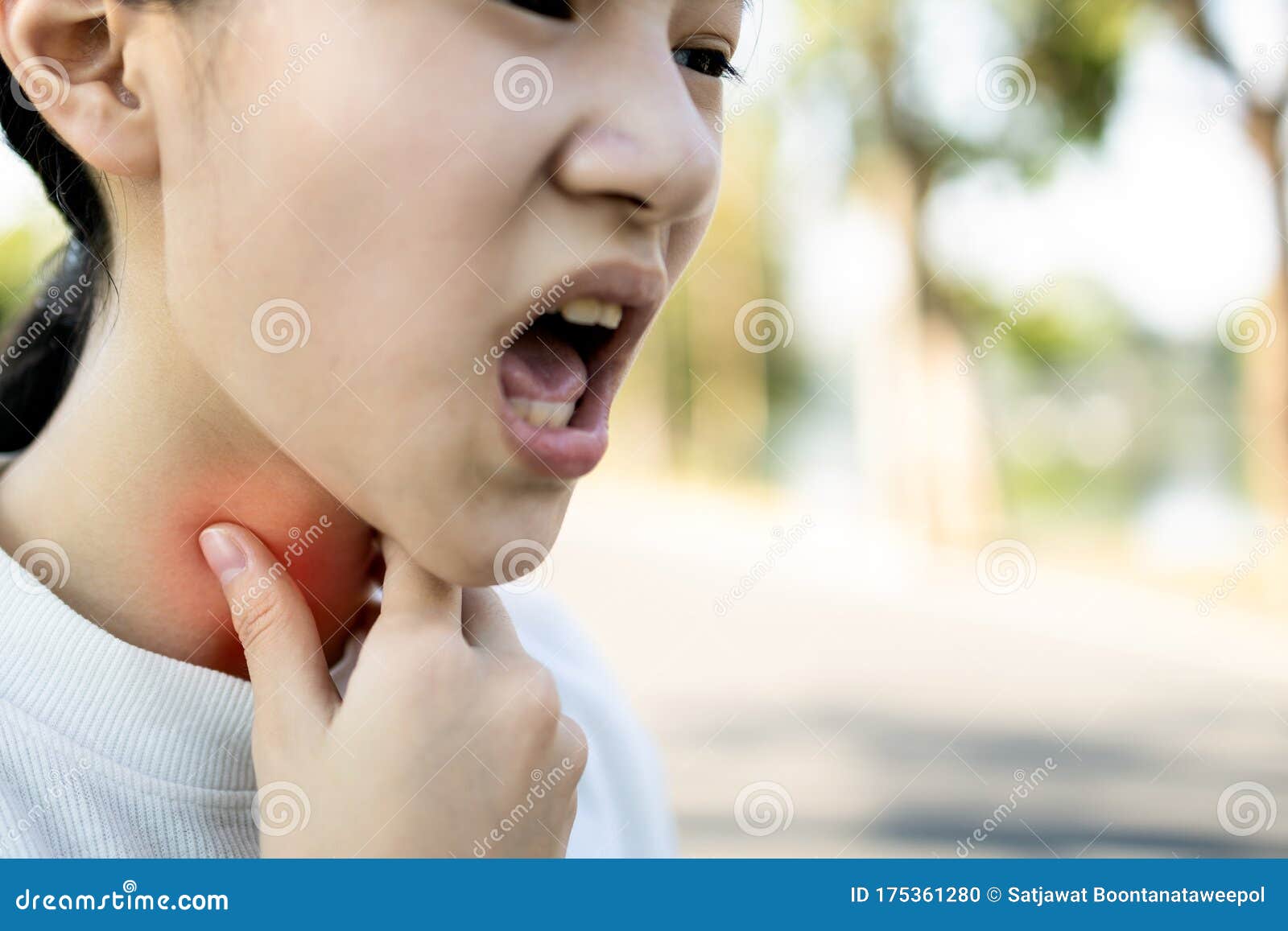 sick asian child girl has sore throat,cough,hoarseness,laryngeal cancer,hand touch her neck,woman with throat problem,tonsillitis