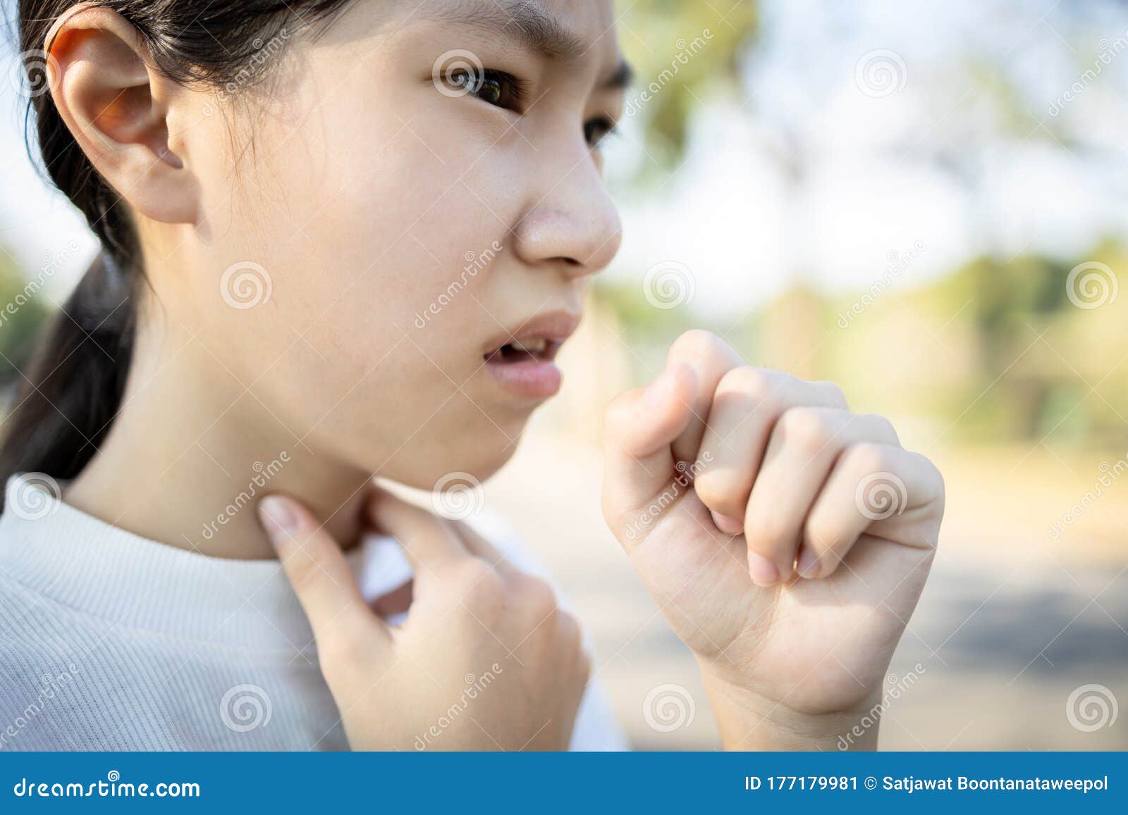 sick asian woman has a chronic cough with tonsillitis,ill child girl touch the neck with fever,acute cough,sore throat pain