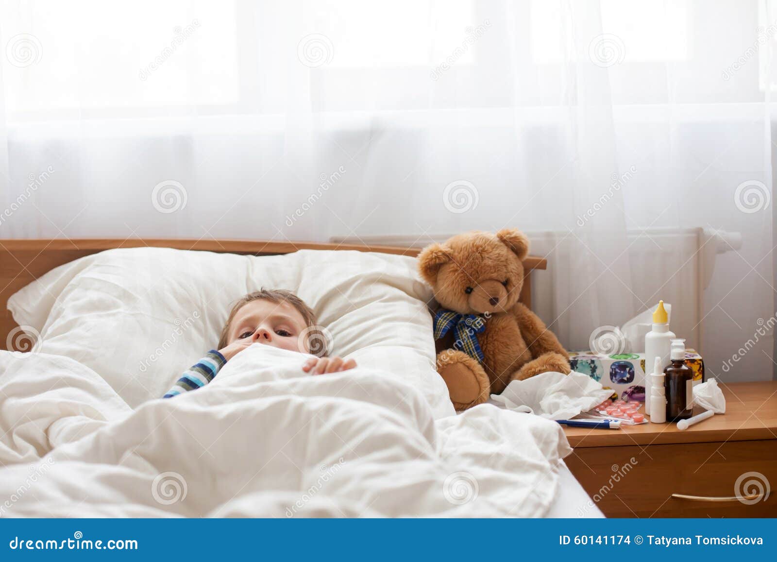 Sick Child Boy Lying in Bed with a Fever, Resting Stock Photo Image