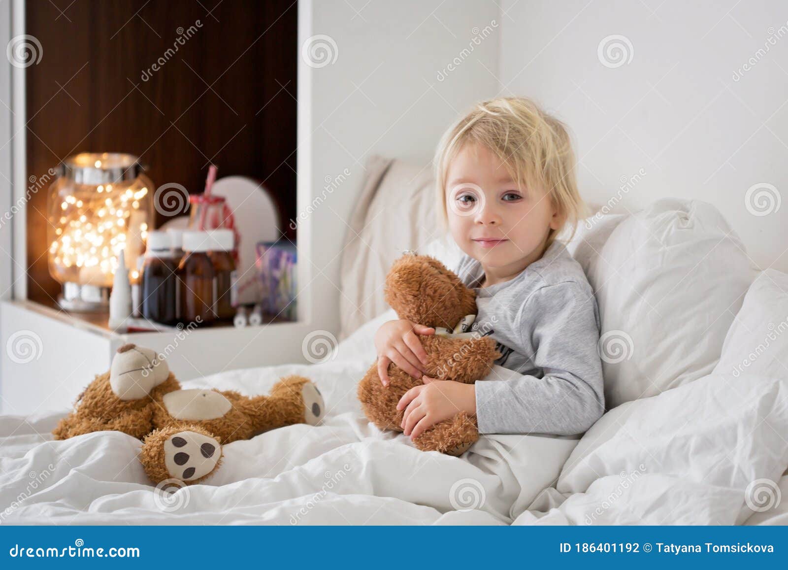 Sick Child Boy Lying in Bed with a Fever, Resting Stock Photo Image