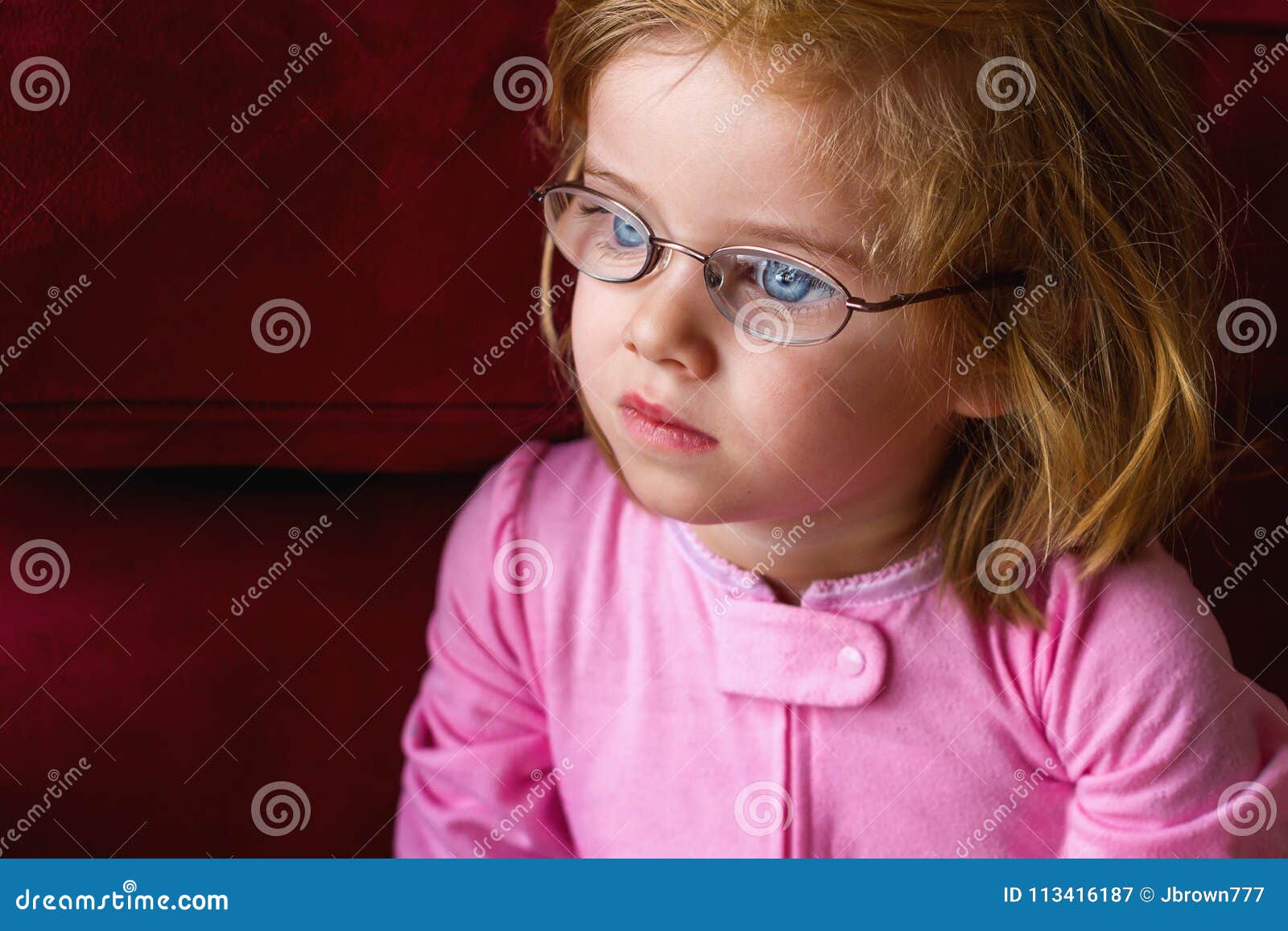 sick girl with very thick glasses and magnified blue eyes
