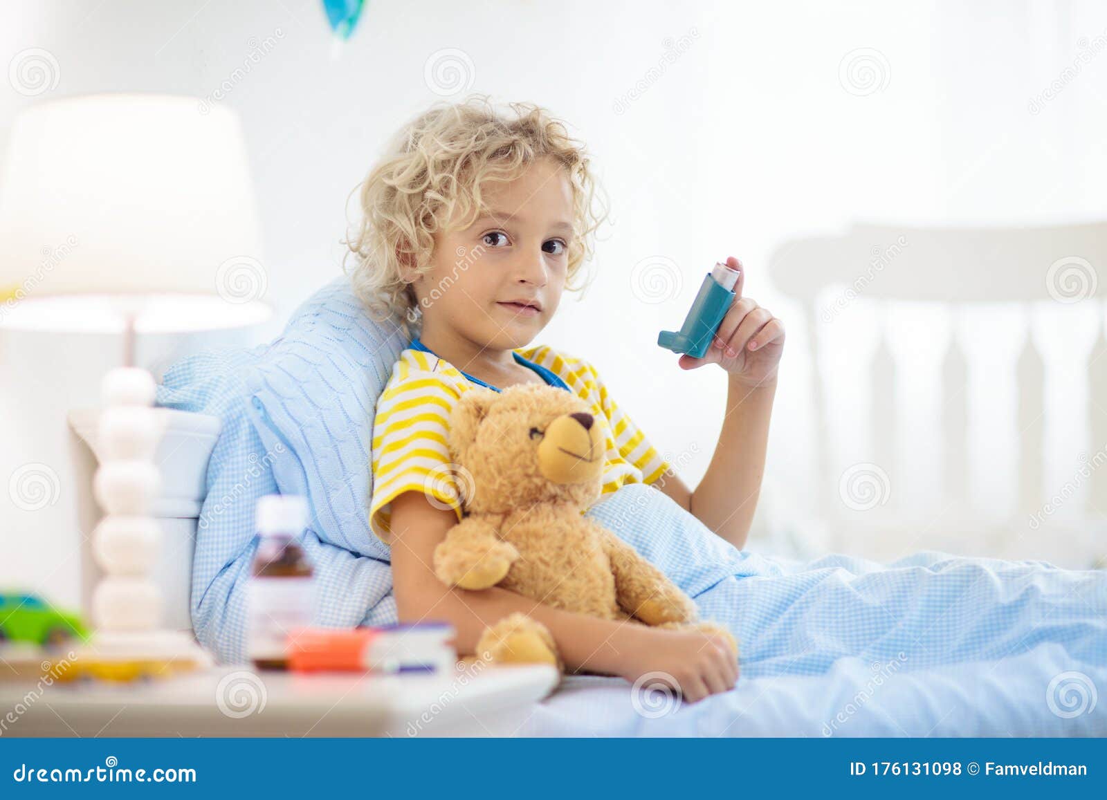 sick little boy with asthma medicine. ill child