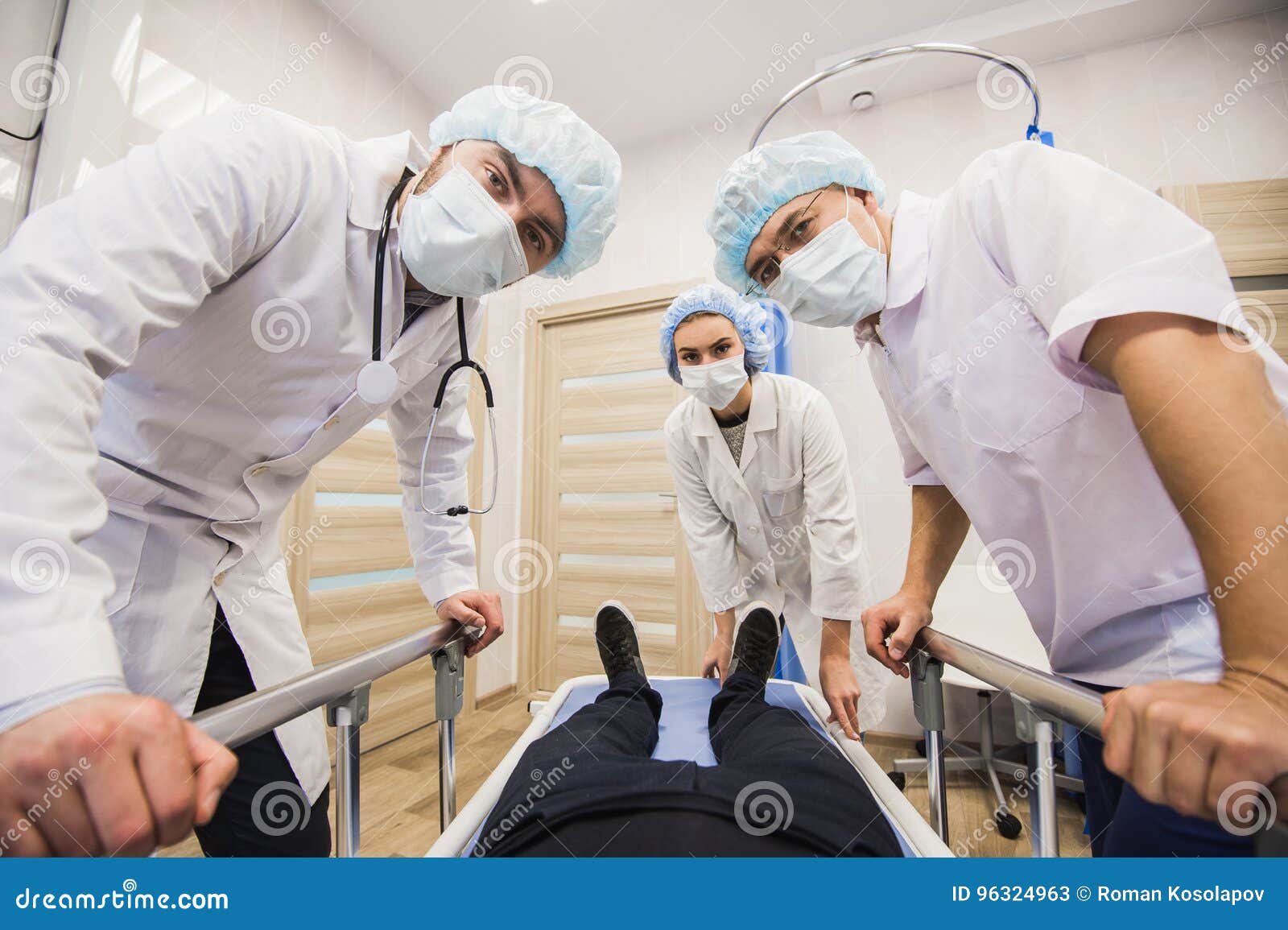 Sick Patient on Gurney in Operating Room with Doctors in Front of Him