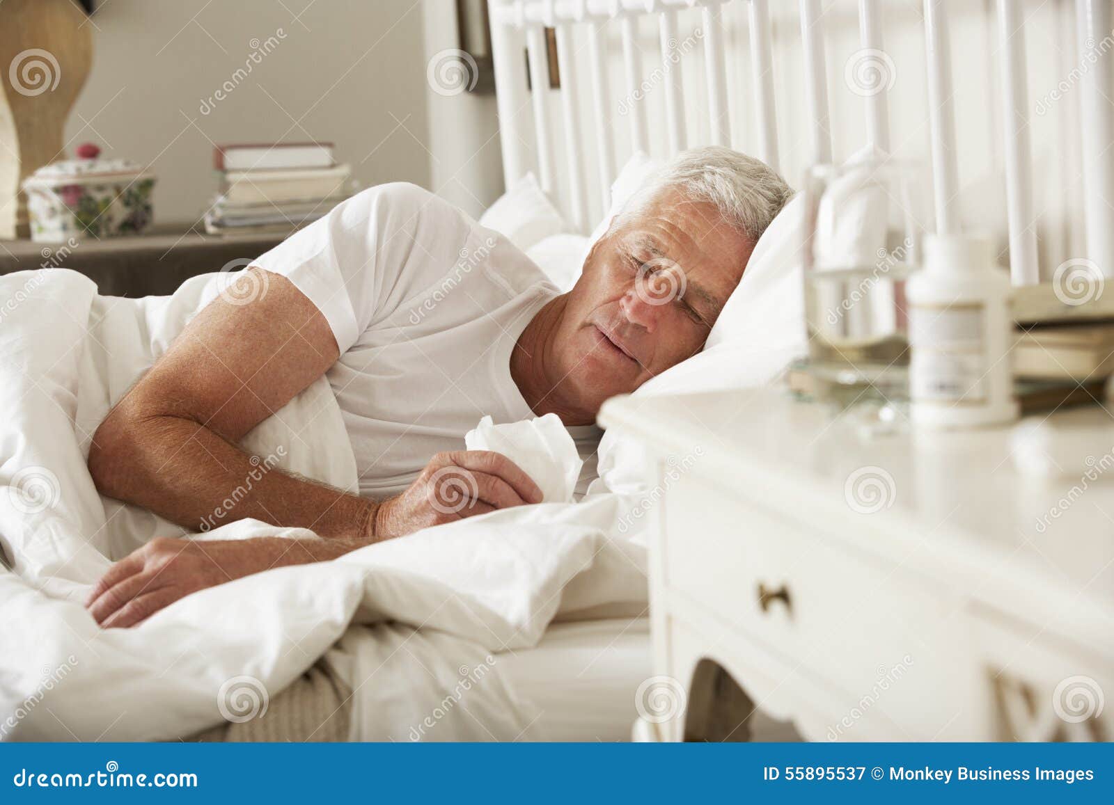 sick senior man in bed at home