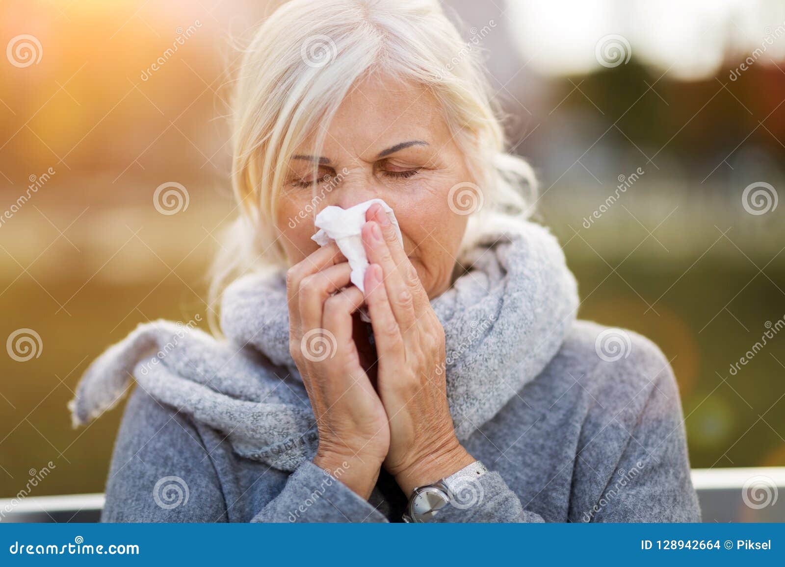senior woman blowing her nose