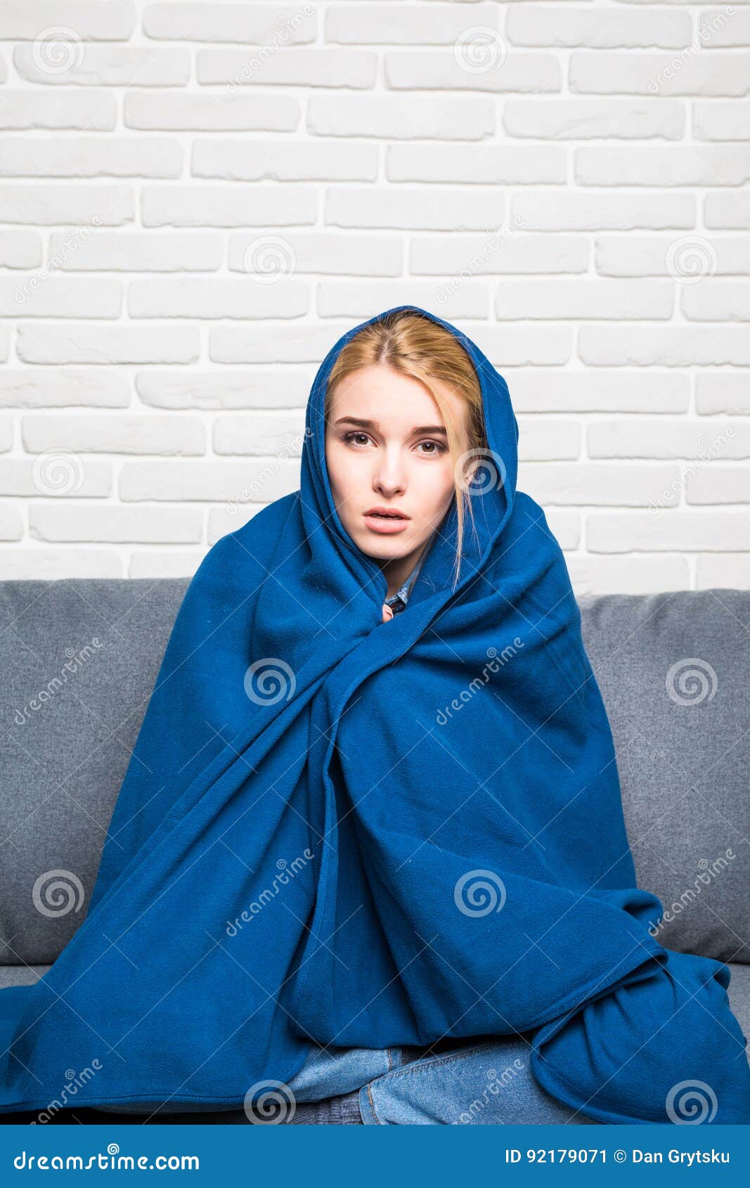 Sick Woman Get Cold with Blanket on Head Sitting on Sofa at Home, Stock